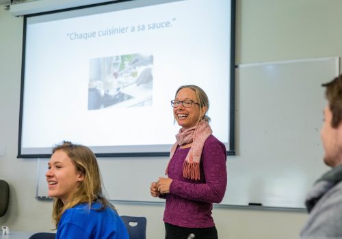 Professor teaching at the front of classroom