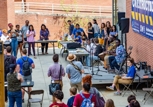 Students giving a music performance outside highsmith